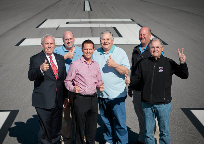 Kit McKeon, Venice City Council member; John Collins, AOPA manager of airport policy; Chris Rozansky, Venice Municipal Airport administrator; Nick Carlucci, VASI president emeritus; Brett Stephens, VASI president; and Paul Hollowell, VASI board of directors, on Runway 5/23 at Venice Municipal Airport. 