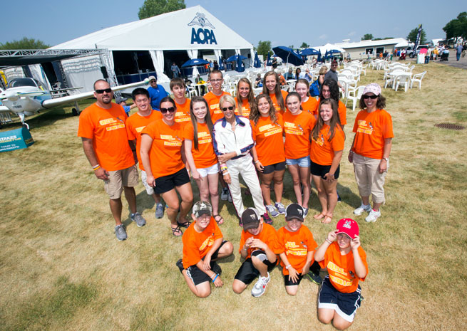 Teacher Eric Vander Loop and students from Appleton, Wisconsin pause for a photo with Patty Wagstaff, National Aviation Hall of Fame pilot and AOPA ambassador. 