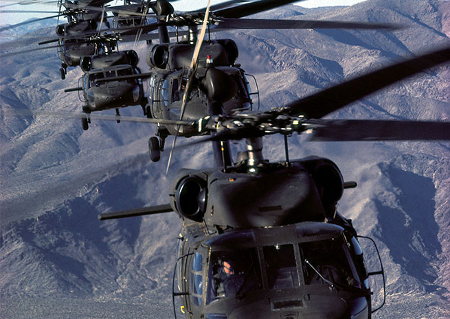 A string of UH-60A Blackhawks fly over mountains in this undated photo from Sikorsky Aircraft.