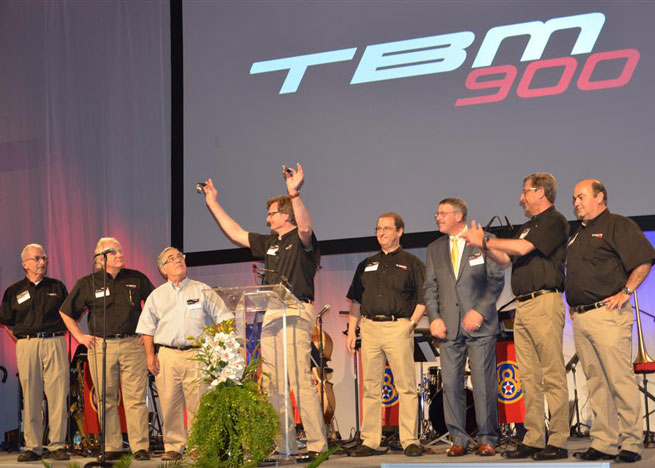 Nicolas Chabbert, senior vice president of the Daher-Socata Business Unit, holds up the keys to the first two TBM 900s in a ceremony at Fantasy of Flight. From left are Ken Dono and Art Maurice of Columbia Aircraft Sales; Larry Glazer, chairman of TBMOPA; Chabbert; Stephane Mayer, CEO of Daher-Socata; Ross Matthews, another new TBM 900 owner; Patrick Daher, chairman and CEO of the Daher Group; and Michel Adam de Villiers, Daher-Socata’s vice president of Aircraft Sales.