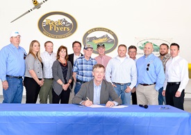 Gov. John Hickenlooper signs Colorado’s tower marking law at Reck Aviation, an aerial application business. Photo courtesy of the Colorado Agricultural Aviation Association.