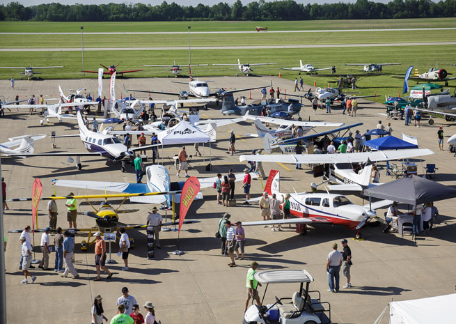 Pilots peruse aircraft on display.