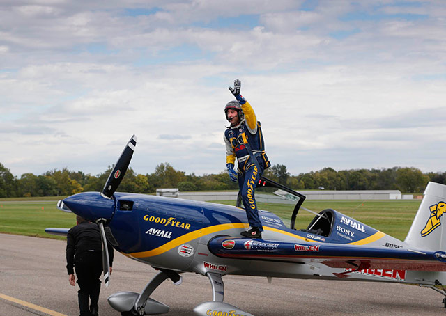 Michael Goulian waves to the crowd after a rousing aerobatic demonstration.