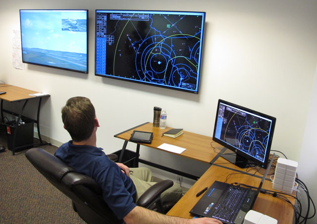 While he monitors virtual flights on a radar-like display in Mindstar Aviation's offices in Leesburg, Virginia, Greg Ashby can see the airport environment with an inset of an aircraft on another screen.