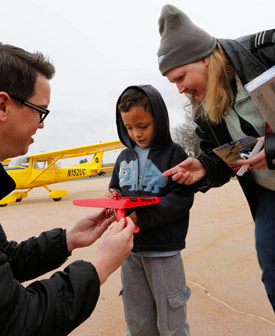 AOPA staff member David Oord gives Caleb a model airplane to celebrate his birthday.