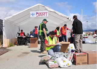 Phil Willis checks in volunteers’ food donations. Photo courtesy of SCAPA/Paul Marshall.