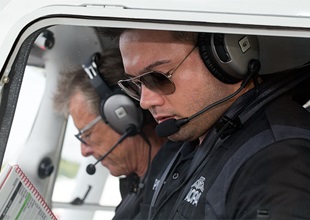 Nik Oekerman gets ready to start the engine with guest instructor Sean D. Tucker alongside.