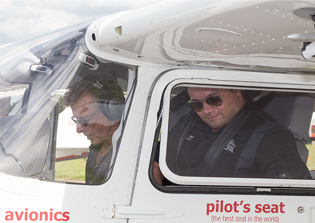 Nik Oekerman gets ready to start the engine with guest instructor Sean D. Tucker alongside.