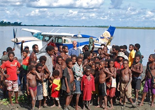 Sepik River villagers crowd around Samaritan Aviation's Mark Palm and the organization's Cessna 206 floatplane in Papua, New Guinea. Photo courtesy of Samaritan Aviation.