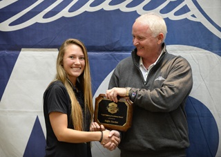Paragon Flight Training's Kayla Harder, from Fort Meyers, Florida, accepts a 2015 Flight Training Excellence Award from AOPA President Mark Baker during a ceremony at AOPA headquarters in Frederick, Maryland, Dec. 2. Photo by David Tulis.
