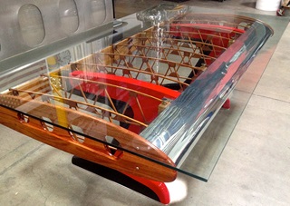 A honey-and-red "Stearman Shorty" wood and aluminum wing has another life as a desk, courtesy of MotoArt. It's reduced in size from its original length to fit residential applications, and pricing starts at $8,900. Photo courtesy of MotoArt.