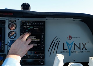 The left side of the L-3 Lynx NGT-9000 is displaying graphical ADS-B traffic information, with textual weather on the right.
