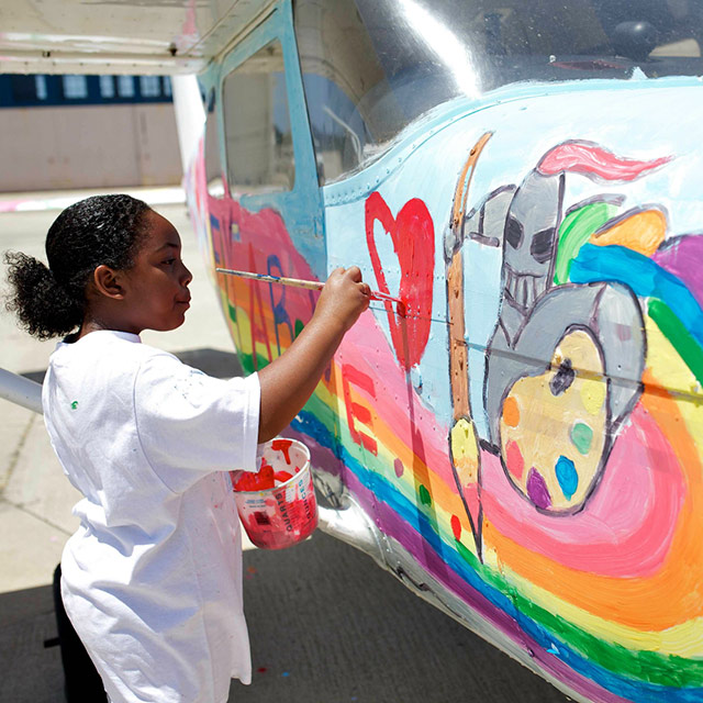 Jaiani Hammonds paints a Cessna 182 through SafeLaunch. Photo courtesy of SafeLaunch.