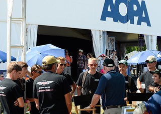 Lakeland AeroClub members, who flew to Oshkosh, Wisconsin, from their home field at Lakeland Linder Regional Airport in Florida, talk with AOPA President Mark Baker at EAA AirVenture 2015 in Oshkosh, Wisconsin, July 23. Photo by David Tulis.