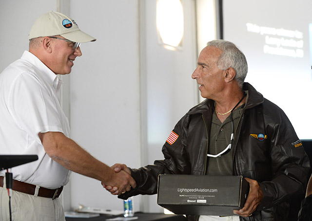IMC Club member Larry Levin receives the group's coveted "Brown Jacket" award from it's president, Radek Wyrzykowski. Photo by David Tulis/AOPA.