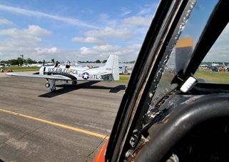 Another T-28 taxies past Gilbert's Trojan at Oshkosh.