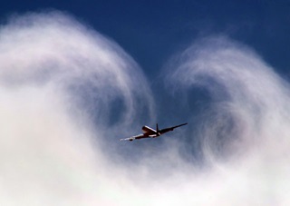 NASA’s DC-8 departs through clouds. NASA photo.