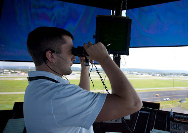 An air traffic controller looks for traffic. AOPA file photo.