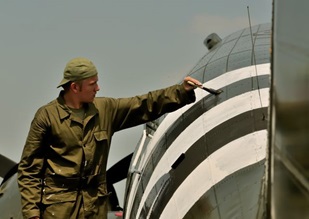 Erik Hokuf paints invasion stripes on the Texas Flying Legends C-53.