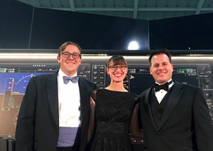 Redbird Flight’s Josh Harnagel (left), Brittney Miculka, and Charlie Gregoire looking dapper on the big sim stage.