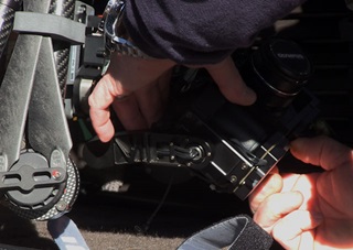 Preparing a gimbal-stabilized digital camera for flight. This customized assembly can accommodate a range of high-end cameras including DSLR and cinema-grade models. 