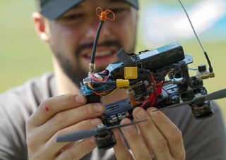 Pilot Josh Noone prepares to race at an event in Stephentown, New York Aug. 14. A task force assembled by the FAA has recommended a registration requirement for all unmanned aircraft that weigh 250 grams or more. Drones like these built for first person view racing weigh about twice that lower limit, or more. Photo by Jim Moore.