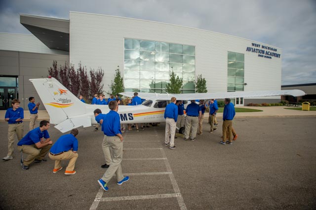 High school students from West Michigan Aviation Academy inspect a 1999 Cessna Skyhawk purchased with funds donated by the Delta Air Lines Foundation. Photo courtesy of Delta/Chris Rank