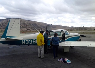 Pilot Dave Robins (right) flew Ken Hetge’s Mooney on one of the relief flights from Tehachapi to Mojave. These two passengers were brought to the airport from the Red Cross shelter and needed to get home to Mojave. Photo courtesy of Ken Hetge.