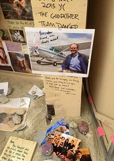 A photo of Pilot Getaways co-founder John Kunis is added to a shrine of messages of love and loss at the Burning Man Temple, which will be torched in a somber moment that ends the annual desert festival. Dave Hirschman/AOPA