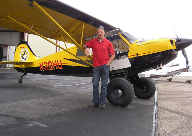 Brian Rowser with the Husky he flew, owned by The Refuge at Alpine Airpark.