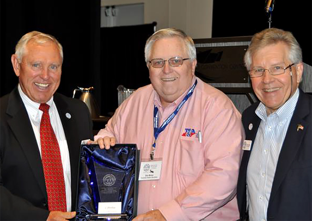 Retired Marine Corps Maj. Gen. Jerry Humble, president of the Kentucky Aviation Association, presents Bob Minter with the Henry Ogrodzinski Excellence in Aviation Award while KAA board member Robert Riggs looks on. Photo courtesy of the Kentucky Aviation Association