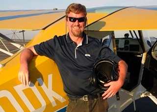 The author is ready to go for the first flight in the U.S. National Championships Aerobatic Box on Sept. 23. A few minutes in the air, ten figures (and three outs, but no zeroes later) did not wipe the smile off of this face. Photo by Wes Liu. 