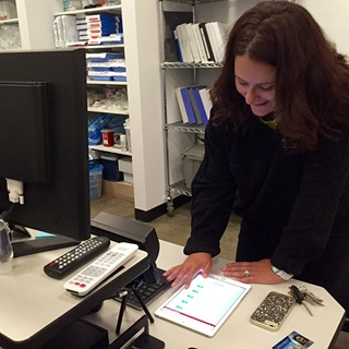 Flight nurse instructor Stephanie Steiner uses an iPad to set up a scenario on the Redbird flight nurse simulator.