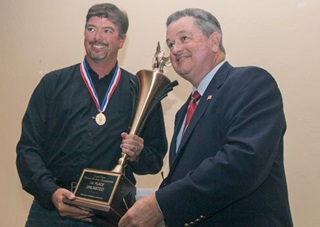 Rob Holland accepts his national championship trophy from IAC President Mike Heuer Sept. 25. Jim Moore photo.