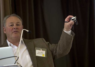 Terry Miller of Transport Risk Management holds up a miniature device that could dramatically change insurance in the drone industry–and beyond. 