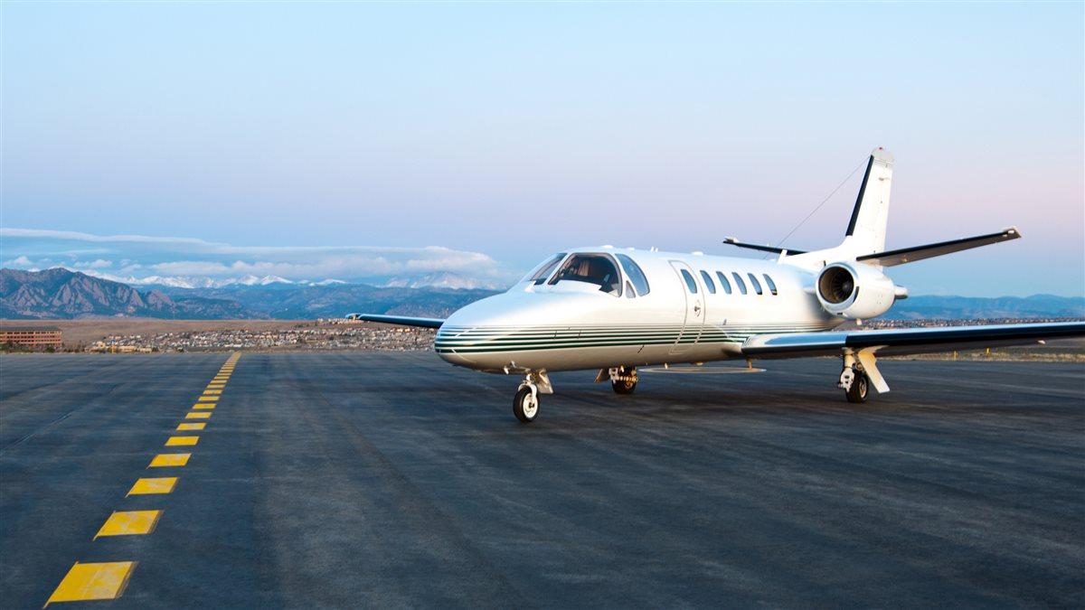 Cessna Citation A Cessna Citation Bravo sitting at the end of ramp in the morning with the picturesque Rocky Mountains in the background.
