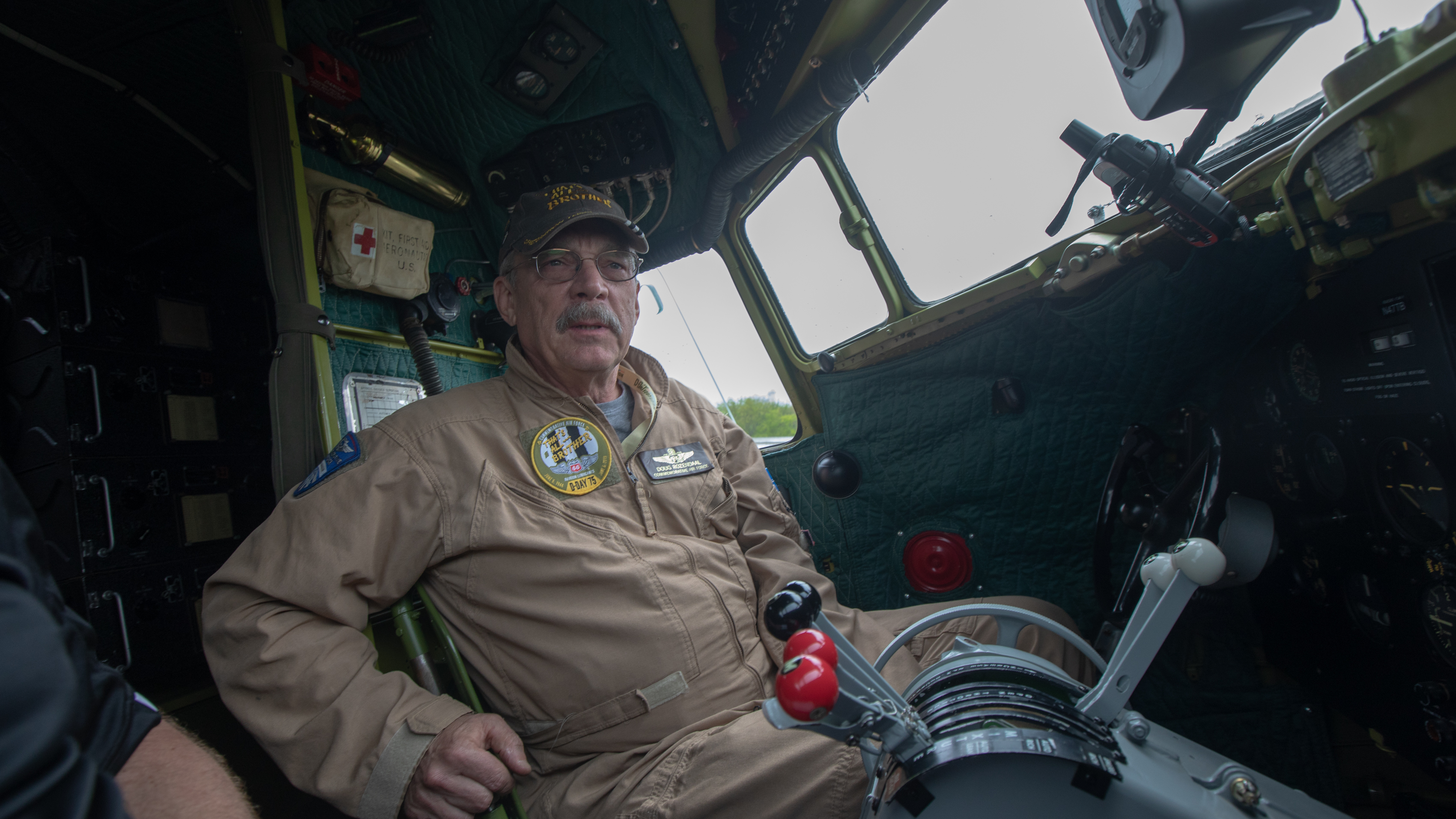 Doug Rozendaal, the Commemorative Air Force pilot of <em>That's All, Brother,</em> gives an interview in the cockpit. Photo by Jim Moore.